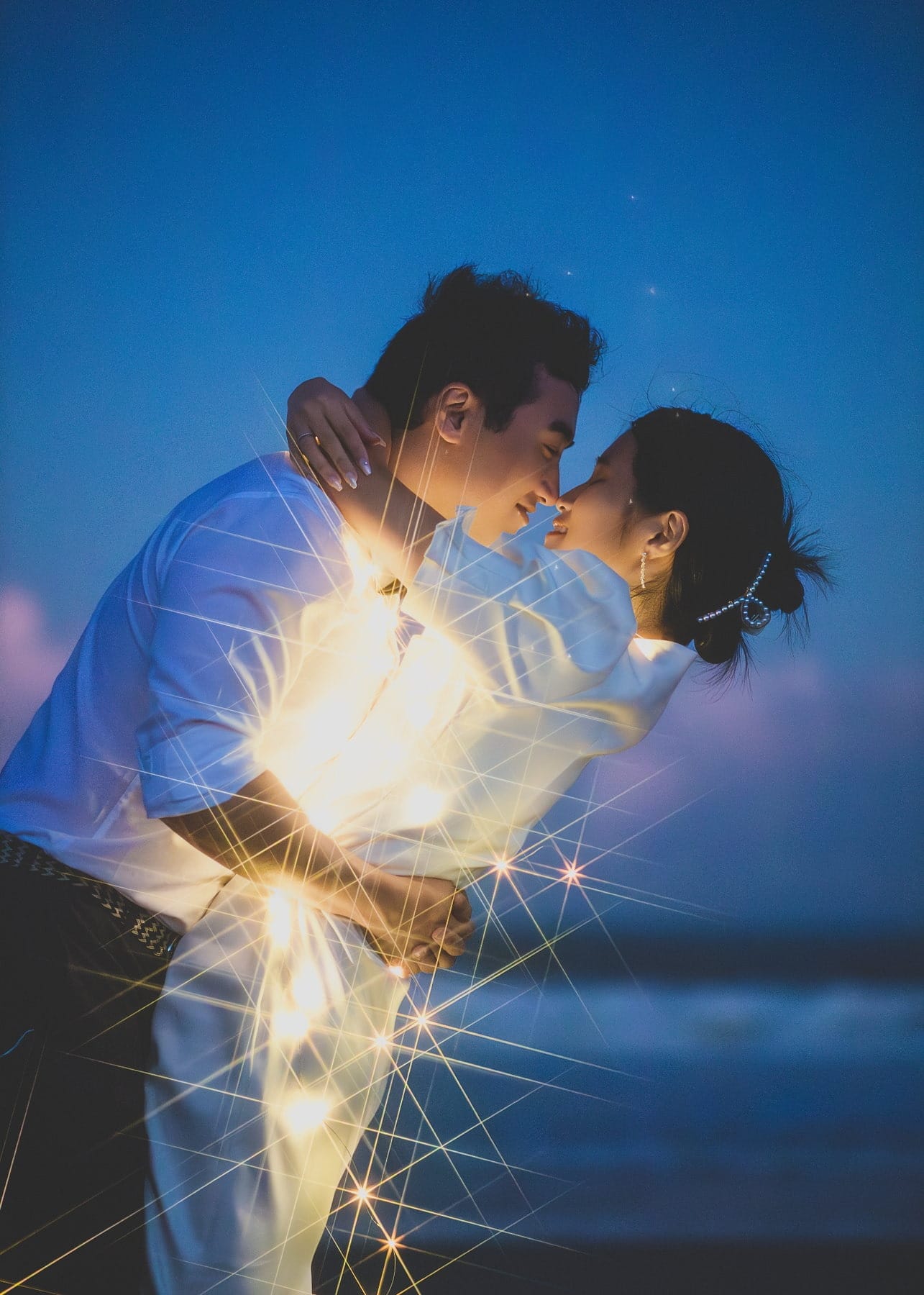 Couple at blue hour surrounded by starburst lights