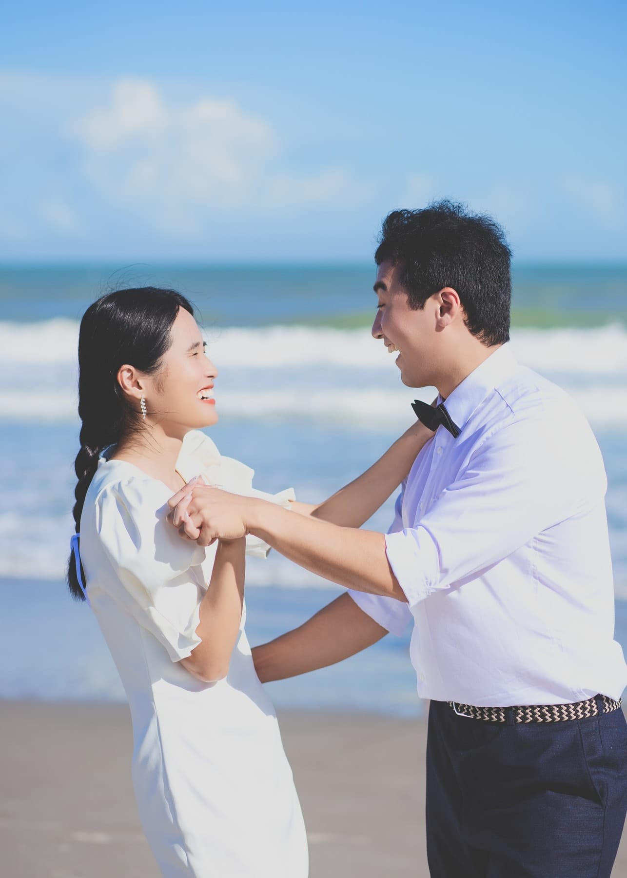 Couple dancing barefoot on the sand