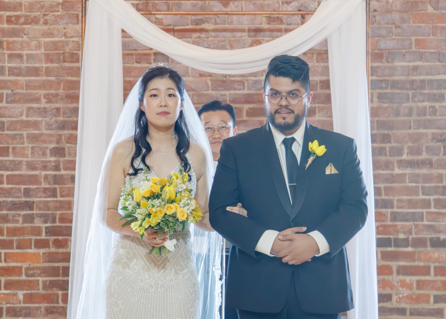 Bride and groom standing together at the altar