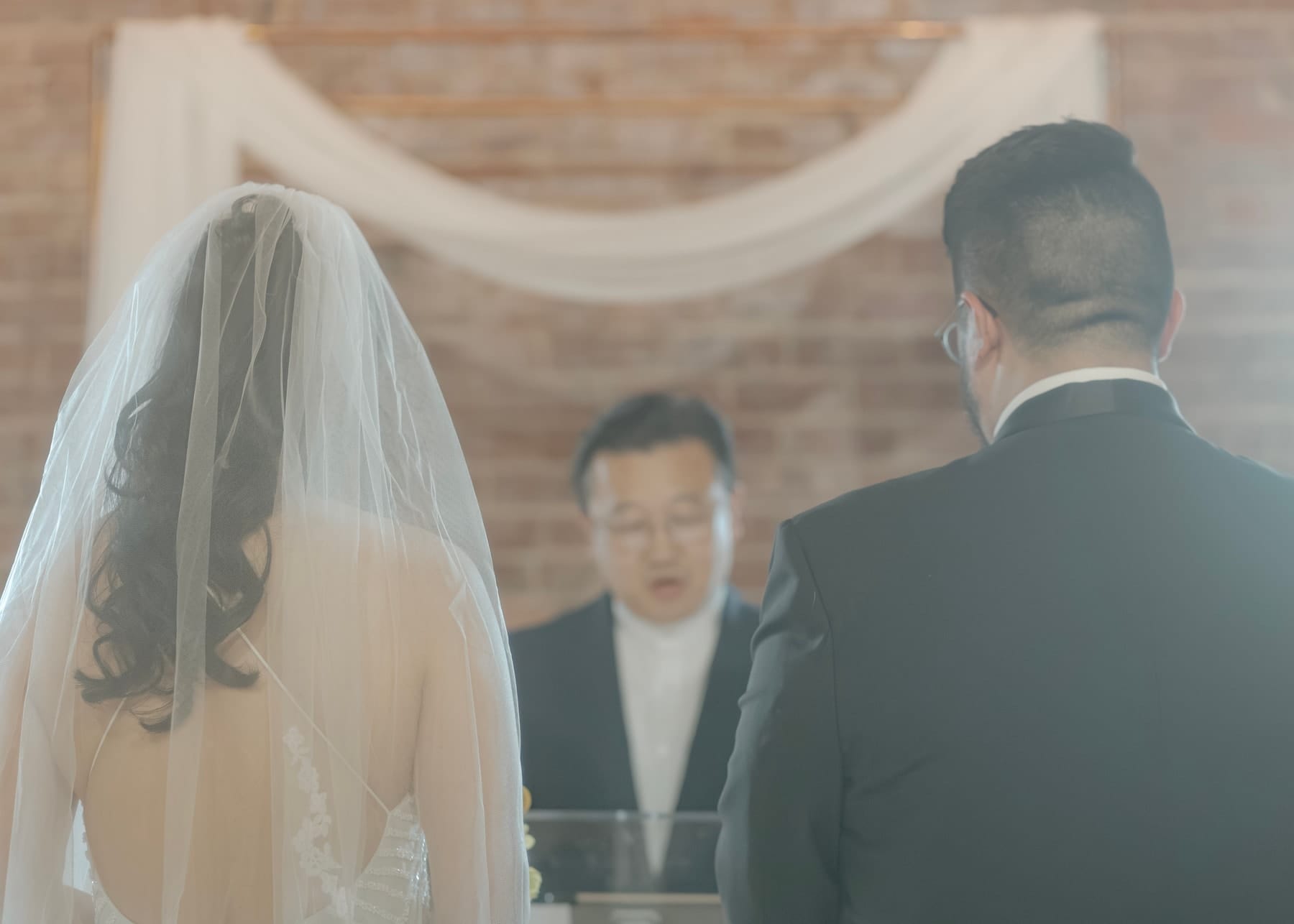 The couple facing the officiant during the vows