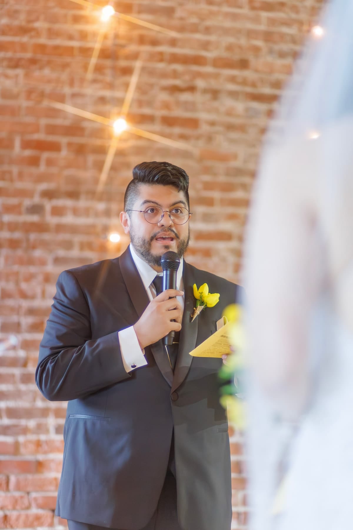 Groom giving a toast with a microphone
