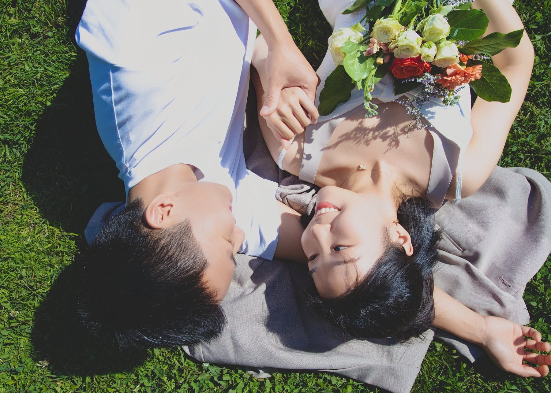 Intimate horizontal portrait of a couple together on the grass