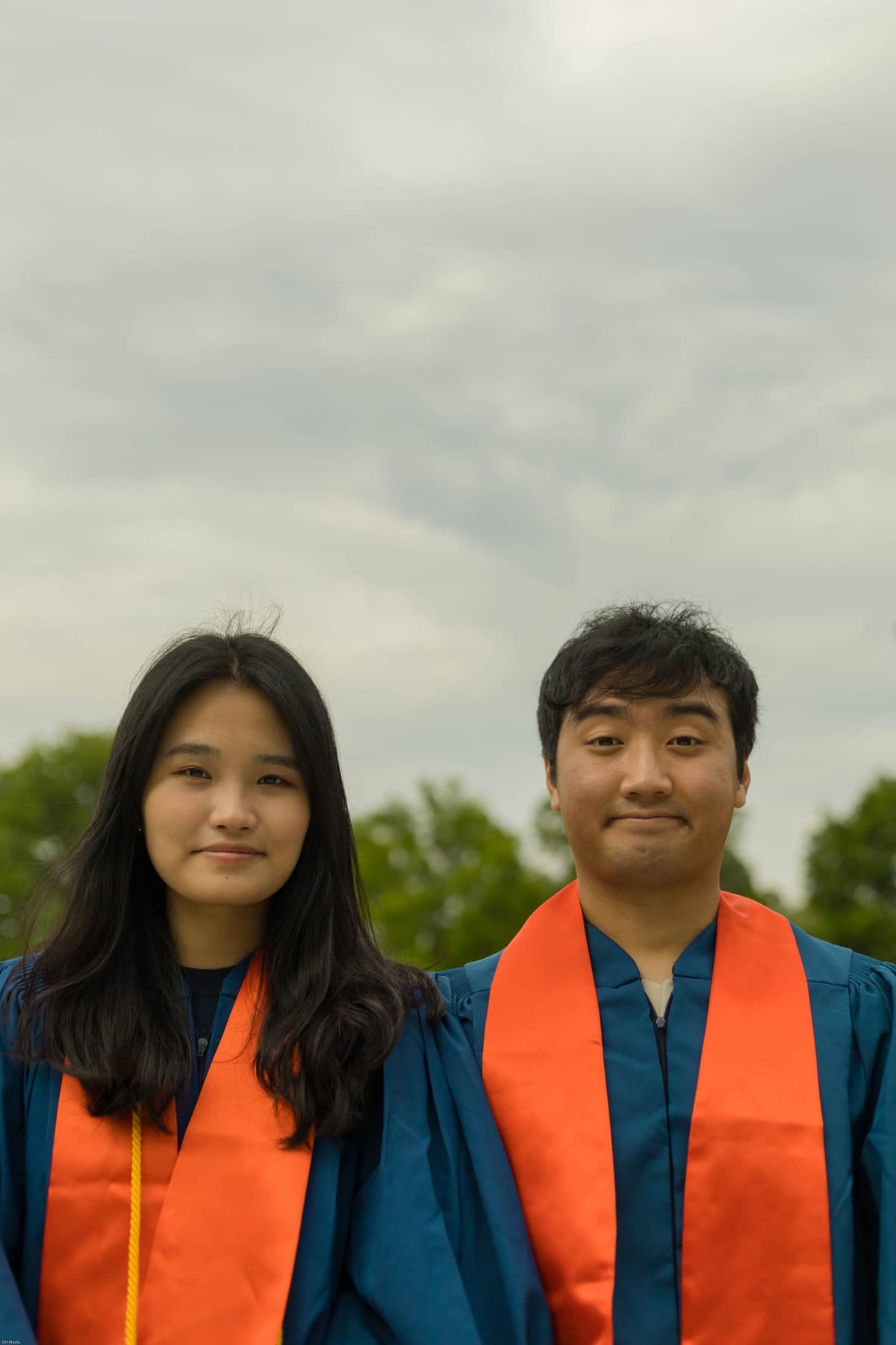 Close portrait of two graduates side by side