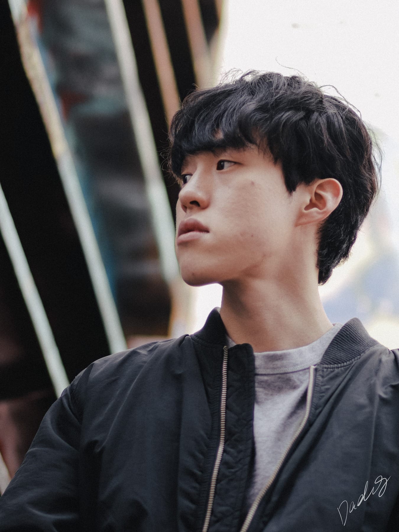 Profile in a dark bomber jacket