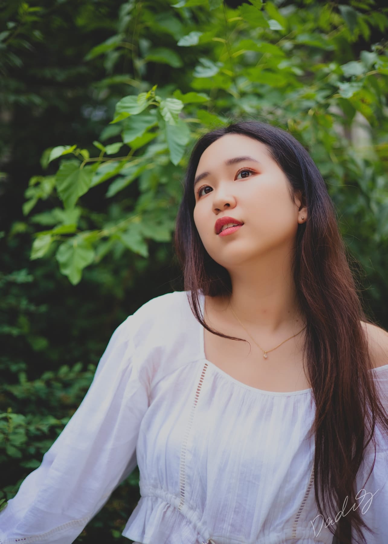 Close portrait against green leaves