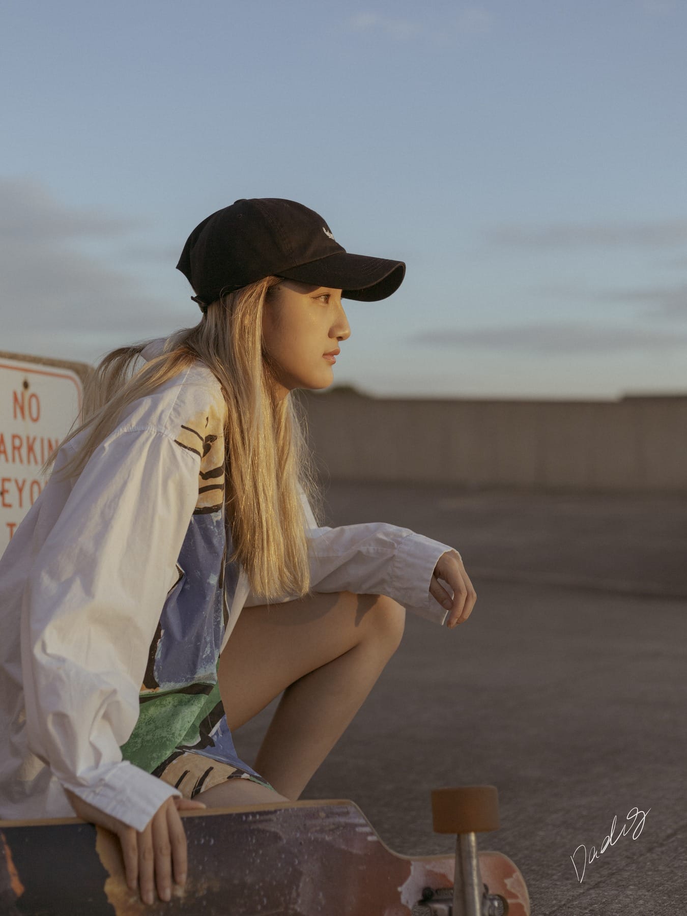 Rooftop portrait with a skateboard at dusk