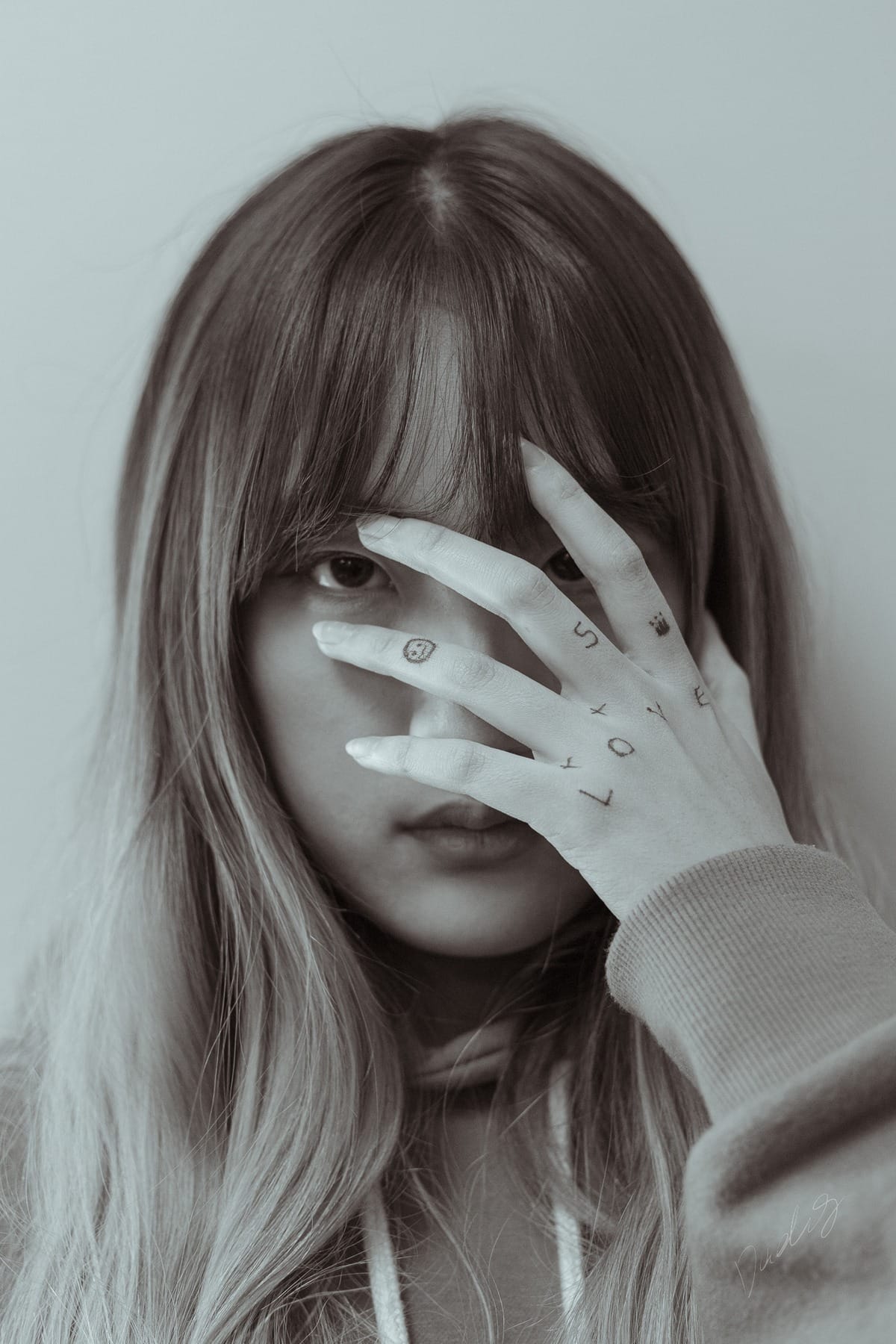 Muted close-up looking through spread fingers